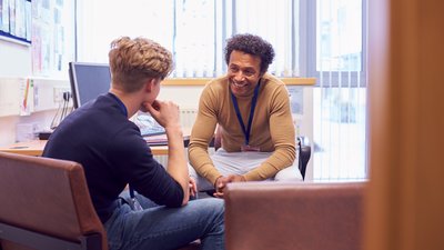 Male counselor speaking with a high school boy